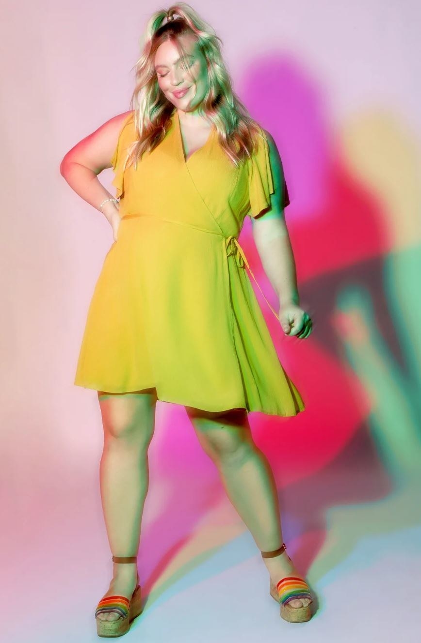 model wearing yellow mini dress