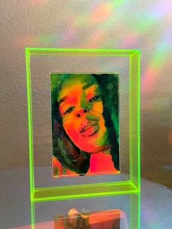 Reviewer's neon green frame shows a piece of artwork