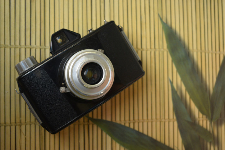 An analog camera placed on a mat