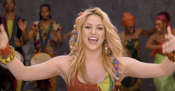 Shakira with her arms raised