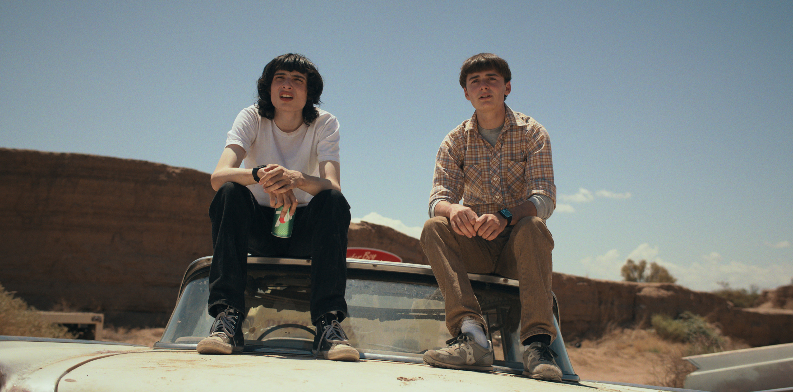 Mike and Will sitting on top of a car