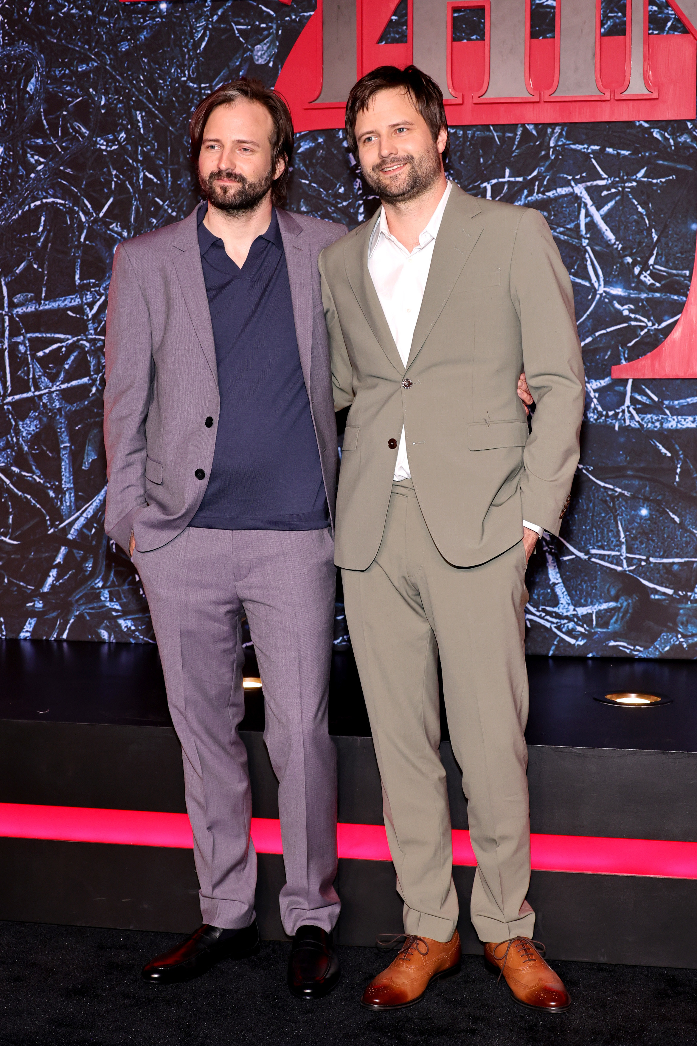 The Duffer brothers standing together