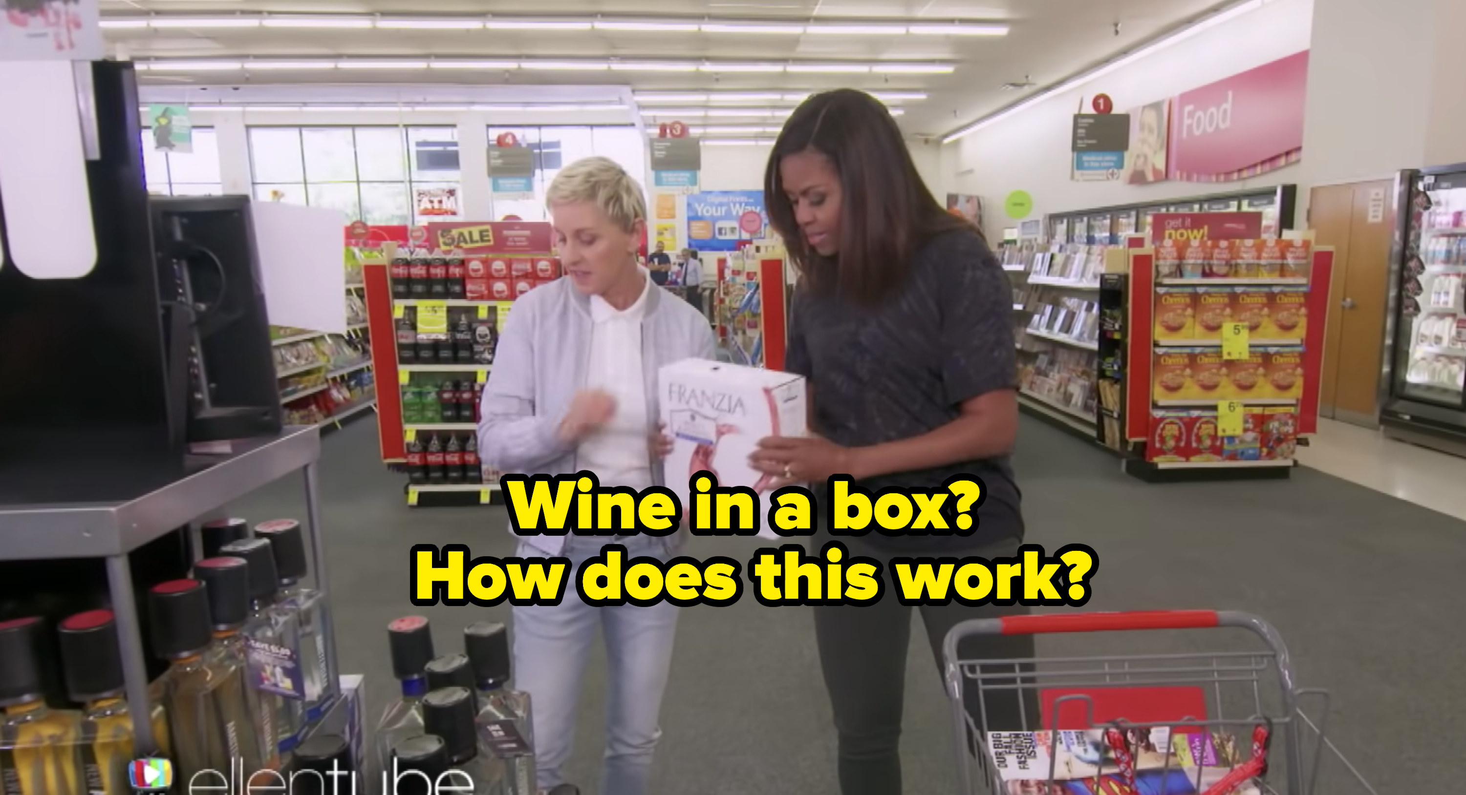 Ellen and Michelle holding a box of wine with the text &quot;Wine in a box? How does this work?