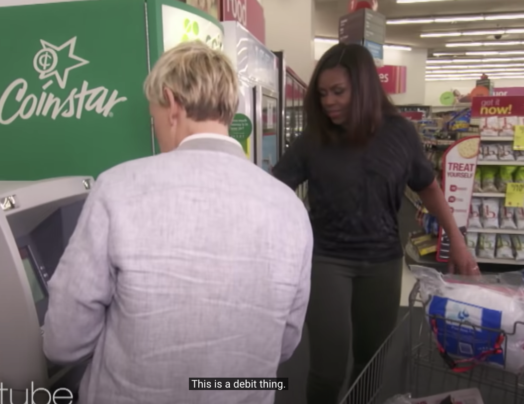 Ellen in front of an ATM saying &quot;This is a debit thing&quot;