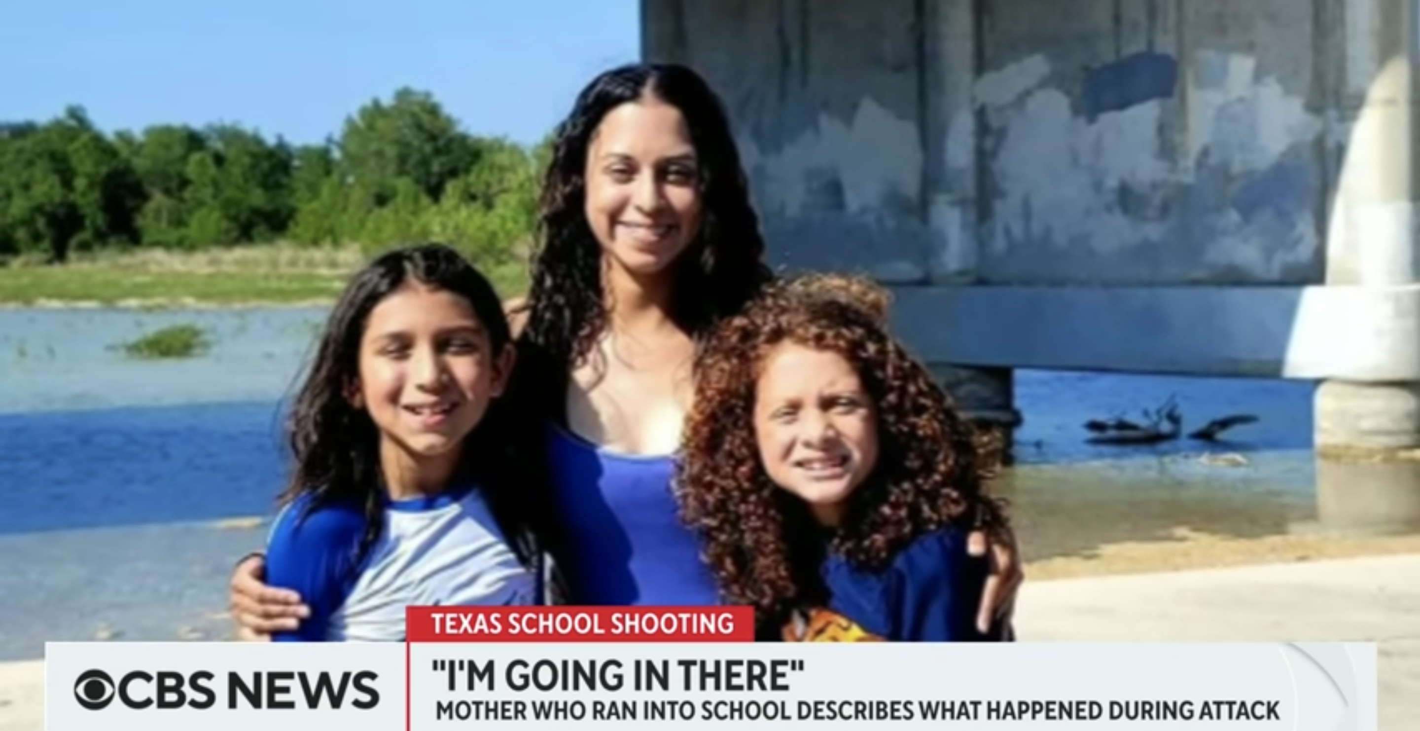 Angeli Gómez speaks to CBS News while embracing two children