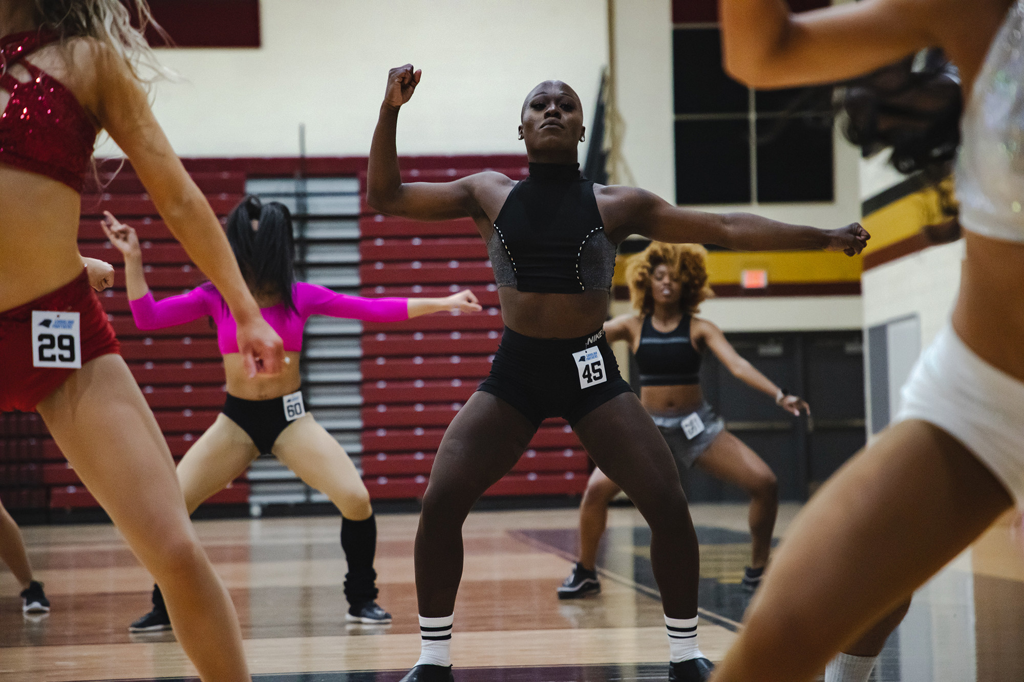 Justine Lindsay performing exercises with others during her audition for the Carolina Panthers