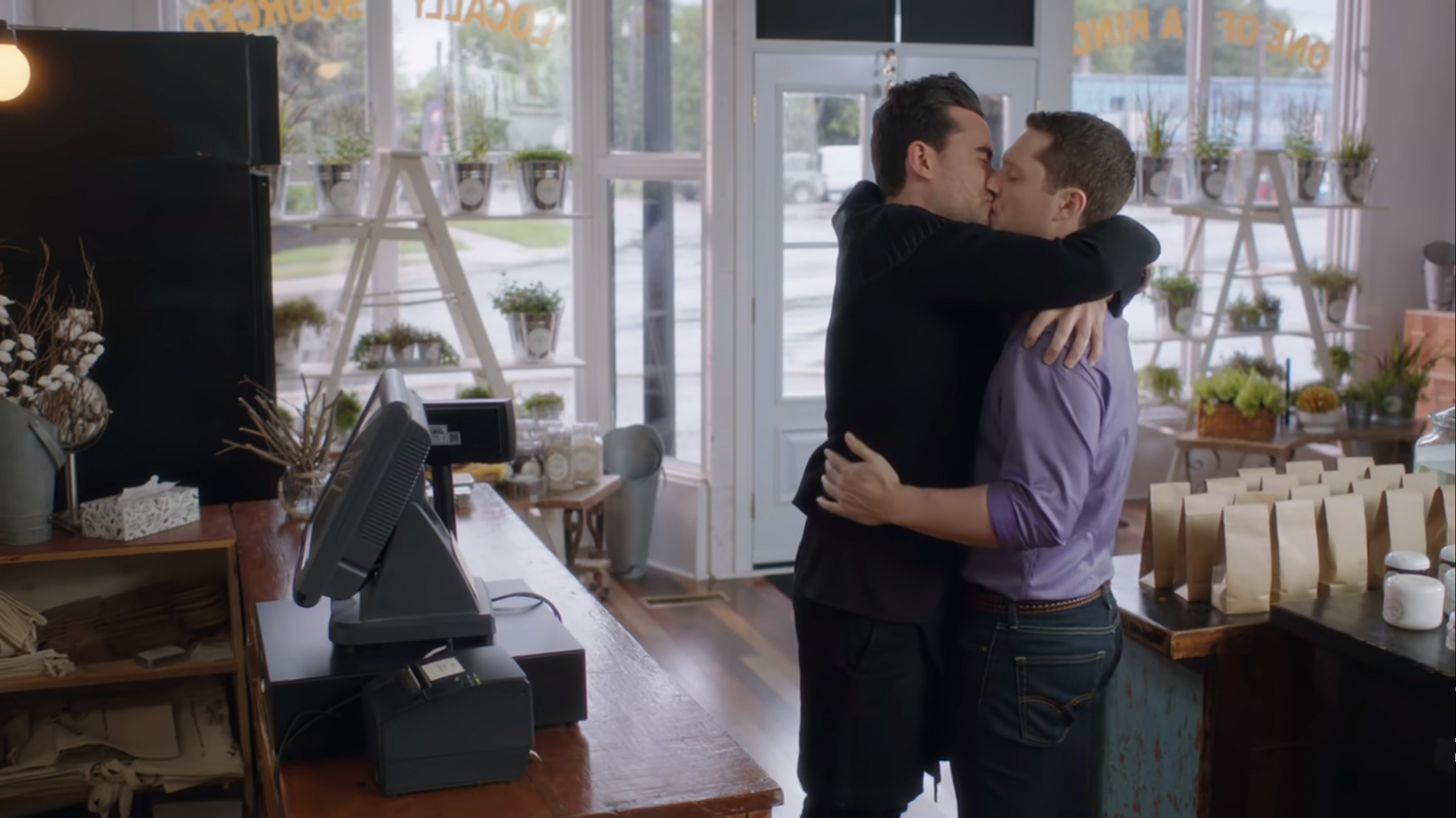 David and Patrick kissing in the middle of their store