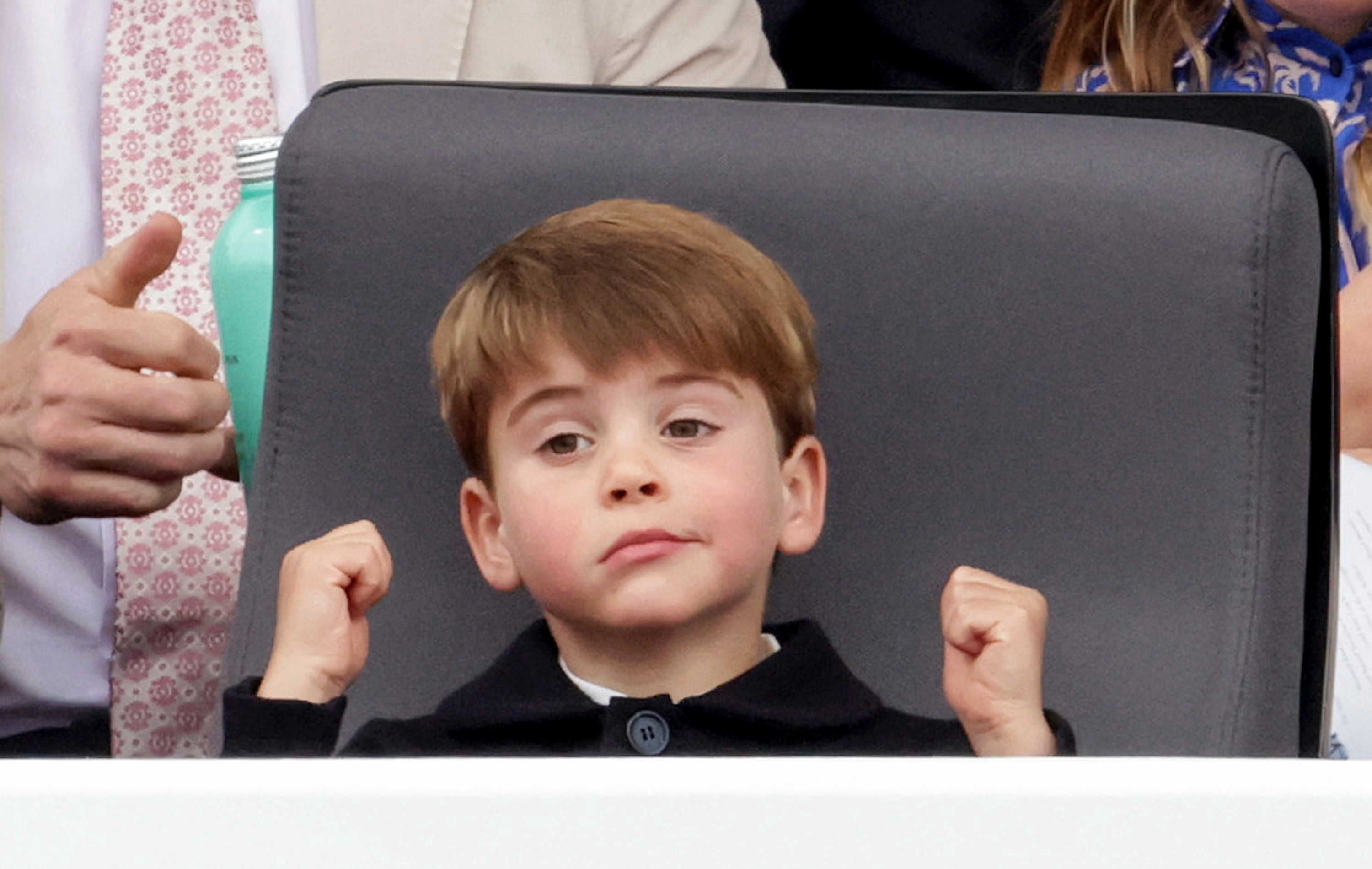 Close-up of Prince Louis with his hands raised