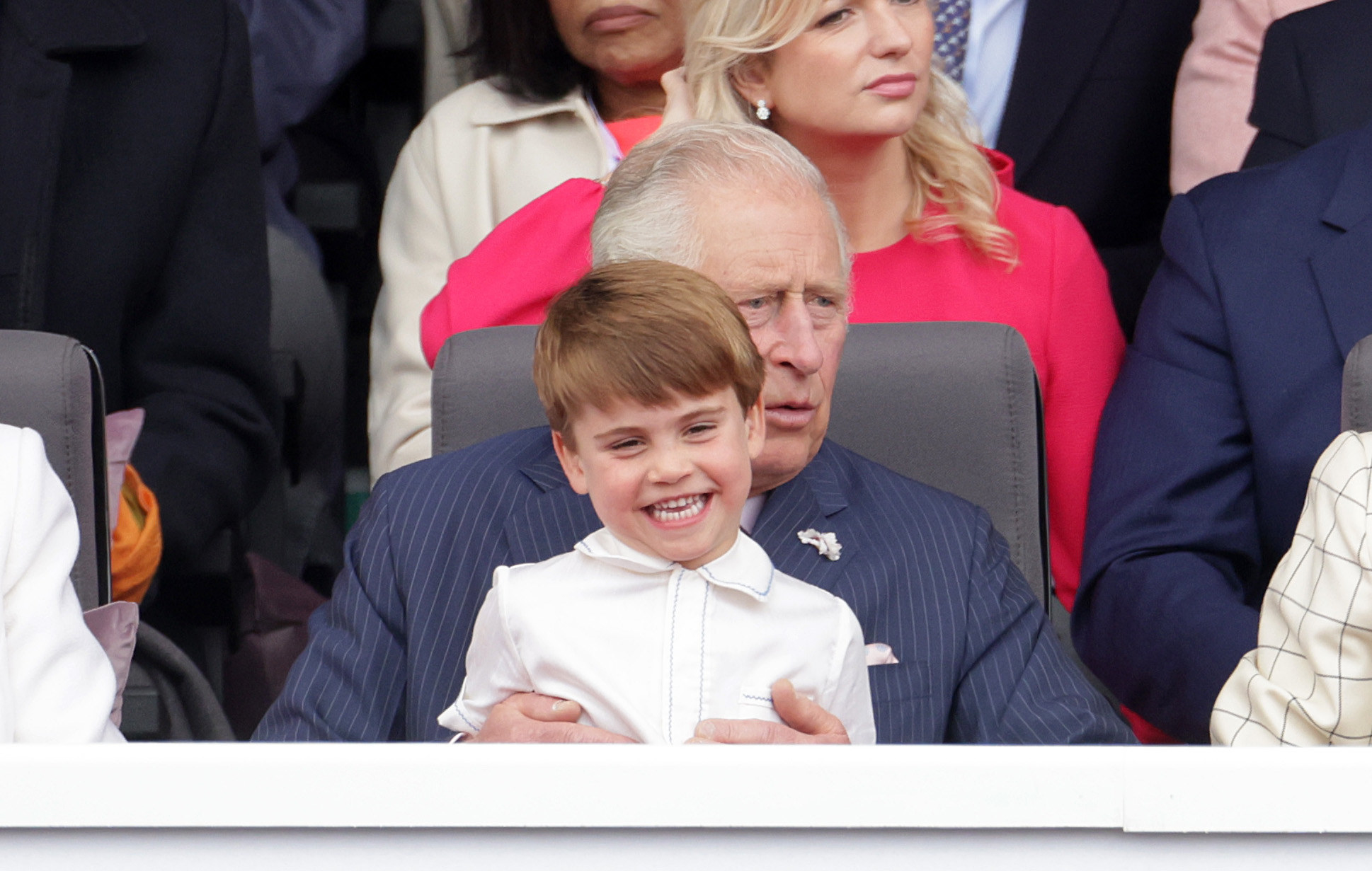Prince Louis smiles while sitting on Prince Charles&#x27; lap