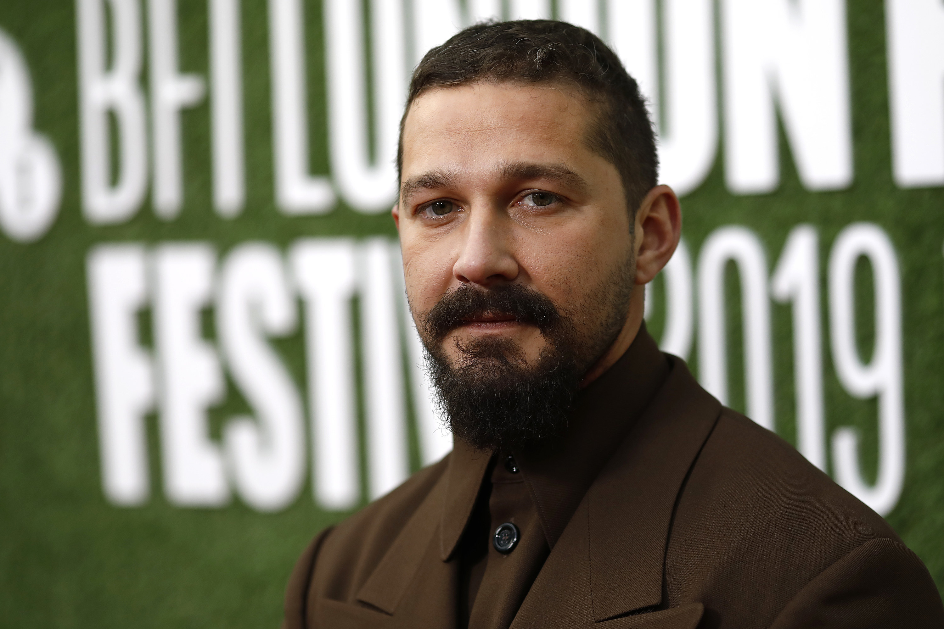 Shia LaBeouf poses on the red carpet in 2019 for the UK premiere of his movie, &quot;The Peanut Butter Falcon&quot;
