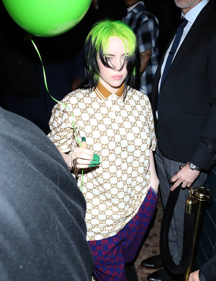 Billie is spotted in LA with her iconic black and green hair and she is holding a green balloon