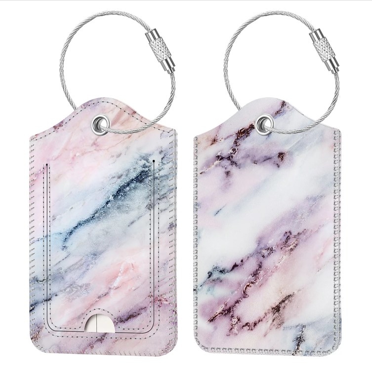 An image of a two faux leather marble pink luggage tags with a stainless steel buckle