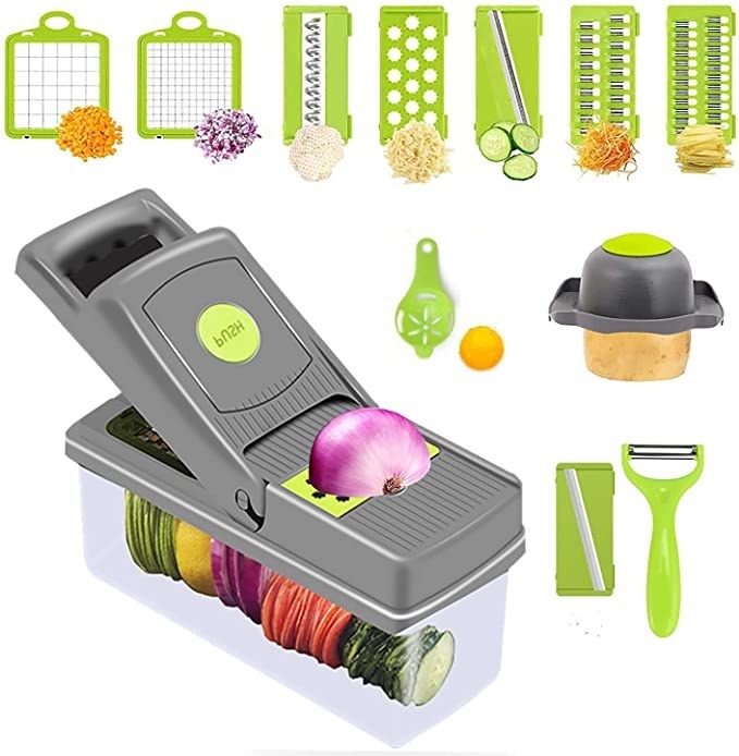 gray vegetable chopper with green peeler and green interchangeable shredding blades