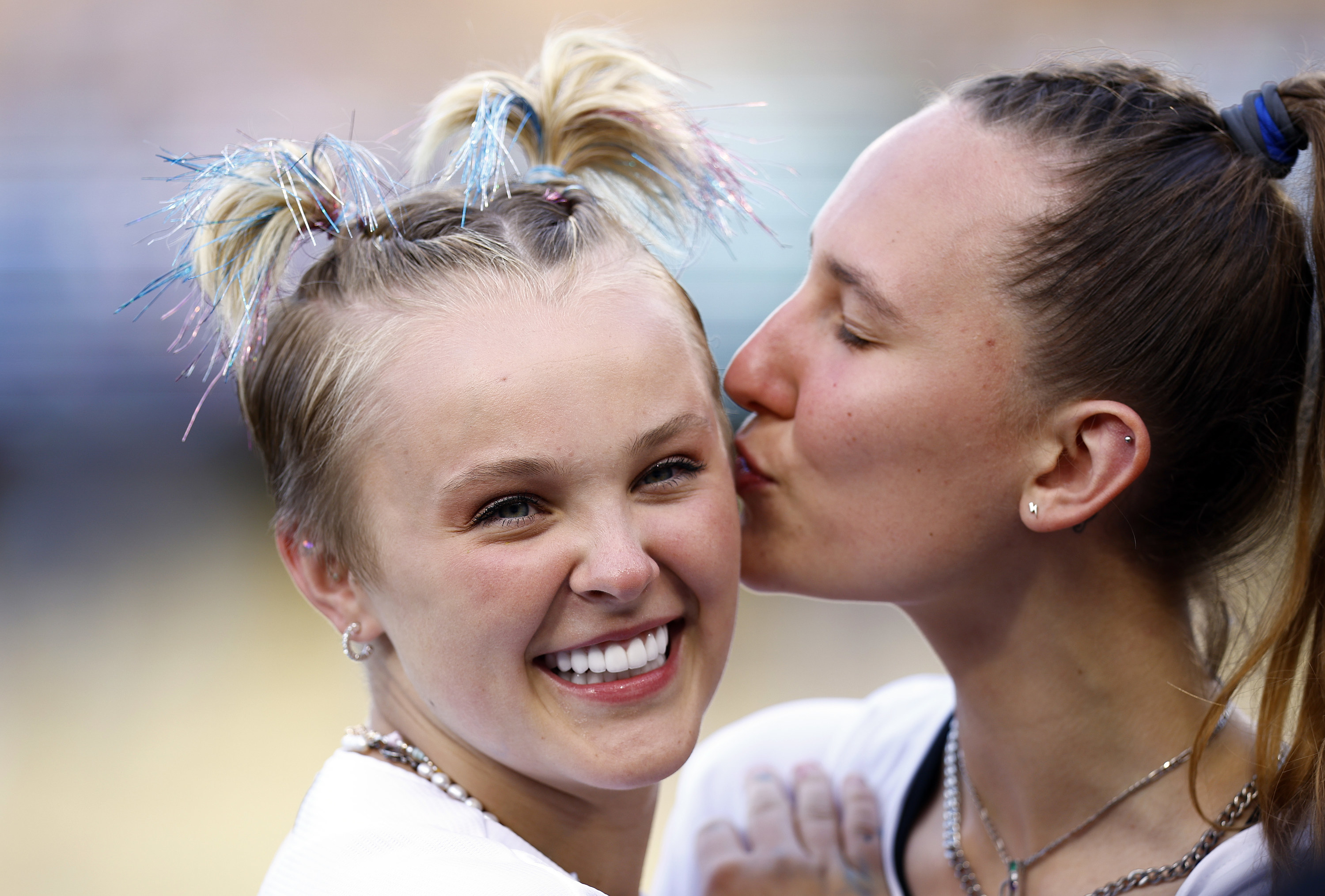 Kylie kissing JoJo on the cheek while JoJo smiles