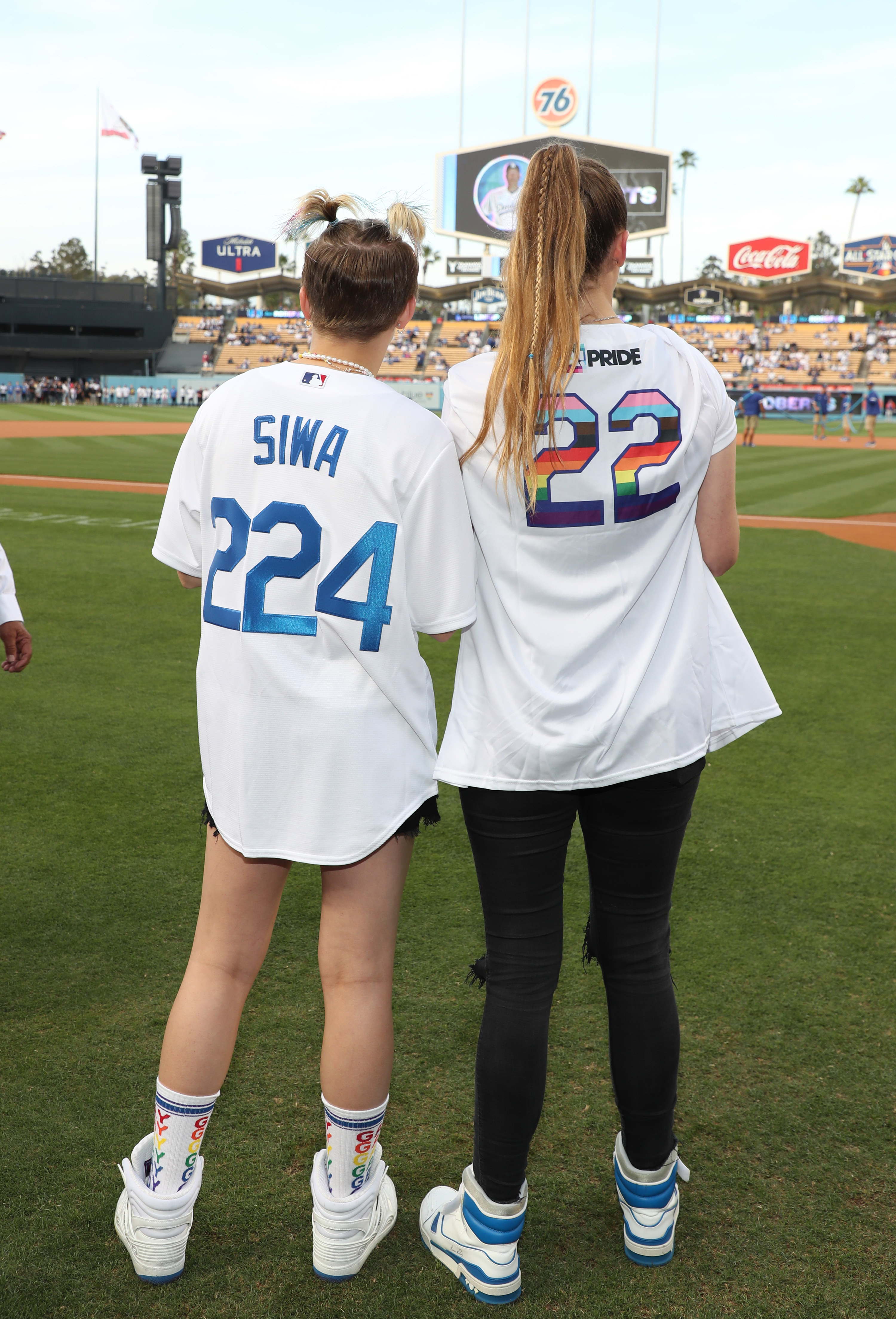JoJo and Kylie from behind, where you can see that JoJo is wearing a custom jersey with her last name and Kylie&#x27;s says &quot;Pride&quot; where the name would normally be