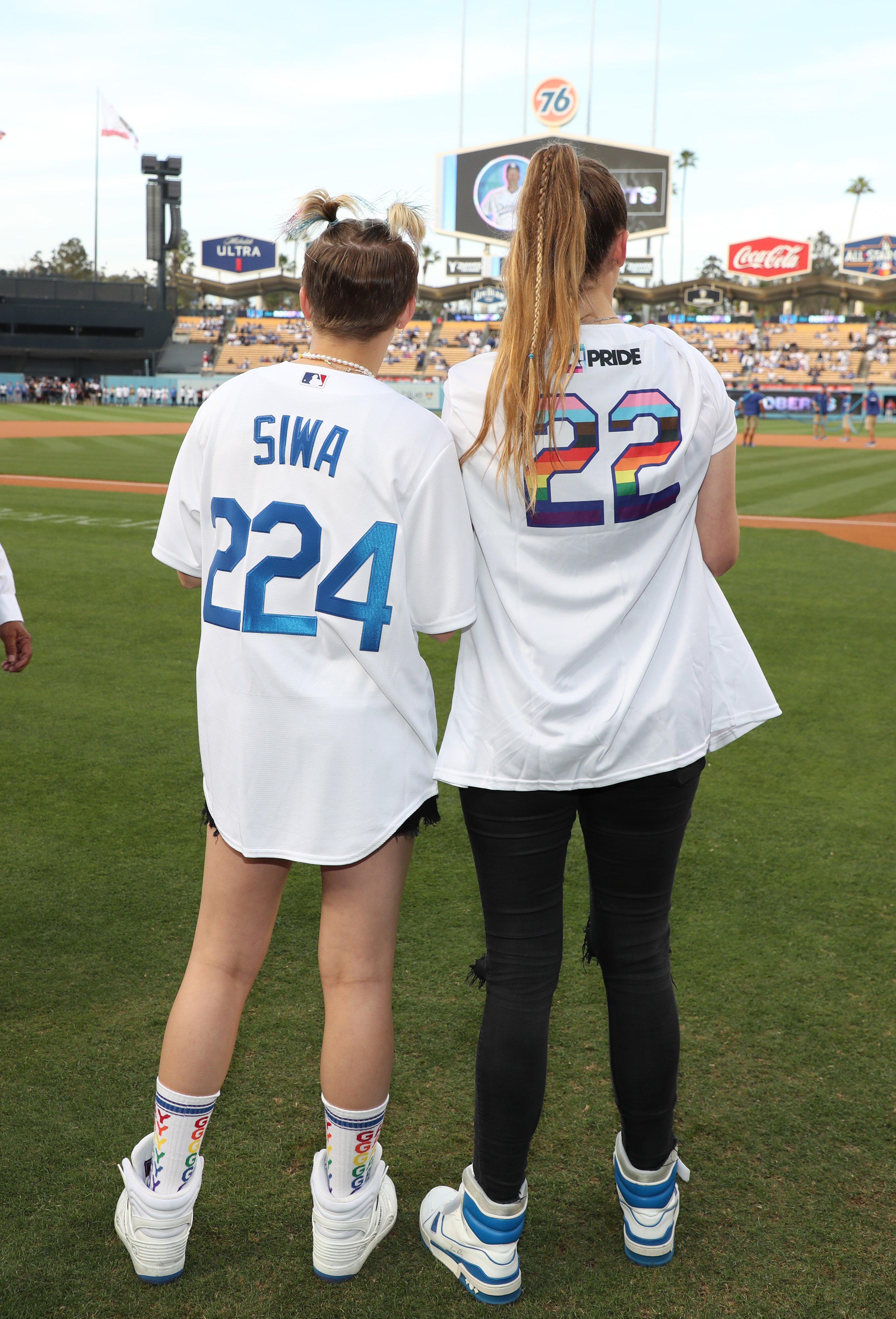 JoJo and Kylie from behind, where you can see that JoJo is wearing a custom jersey with her last name and Kylie's says "Pride" where the name would normally be