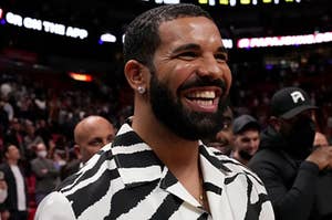Drake wears a zebra print short sleeve shirt