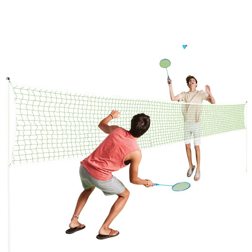 Two people play on opposite sides of a badminton net