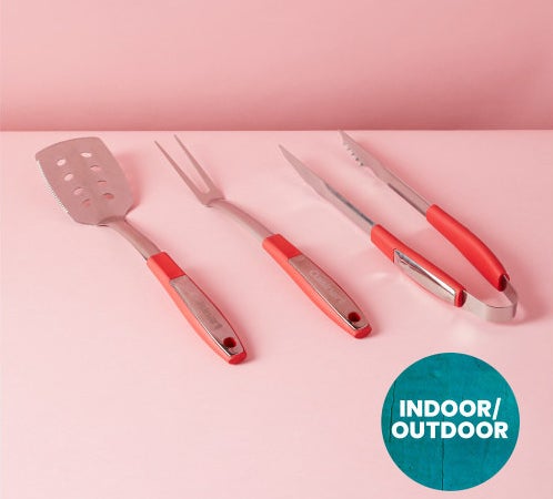 A set of metal grilling utensils including spatula, grilling fork, and tongs