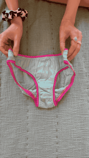 A GIF of Lara demonstrating how to fold underwear following the previously described technique