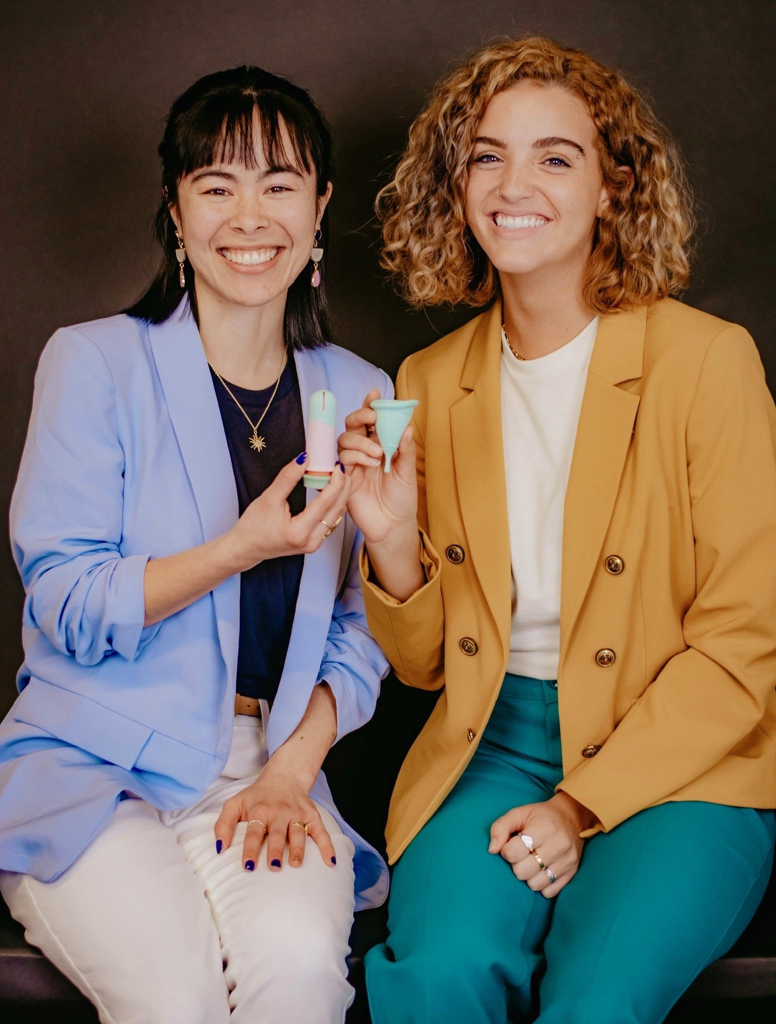 Cindy Belardo and Drew Jarvis holding a Sunny menstrual cup and applicator