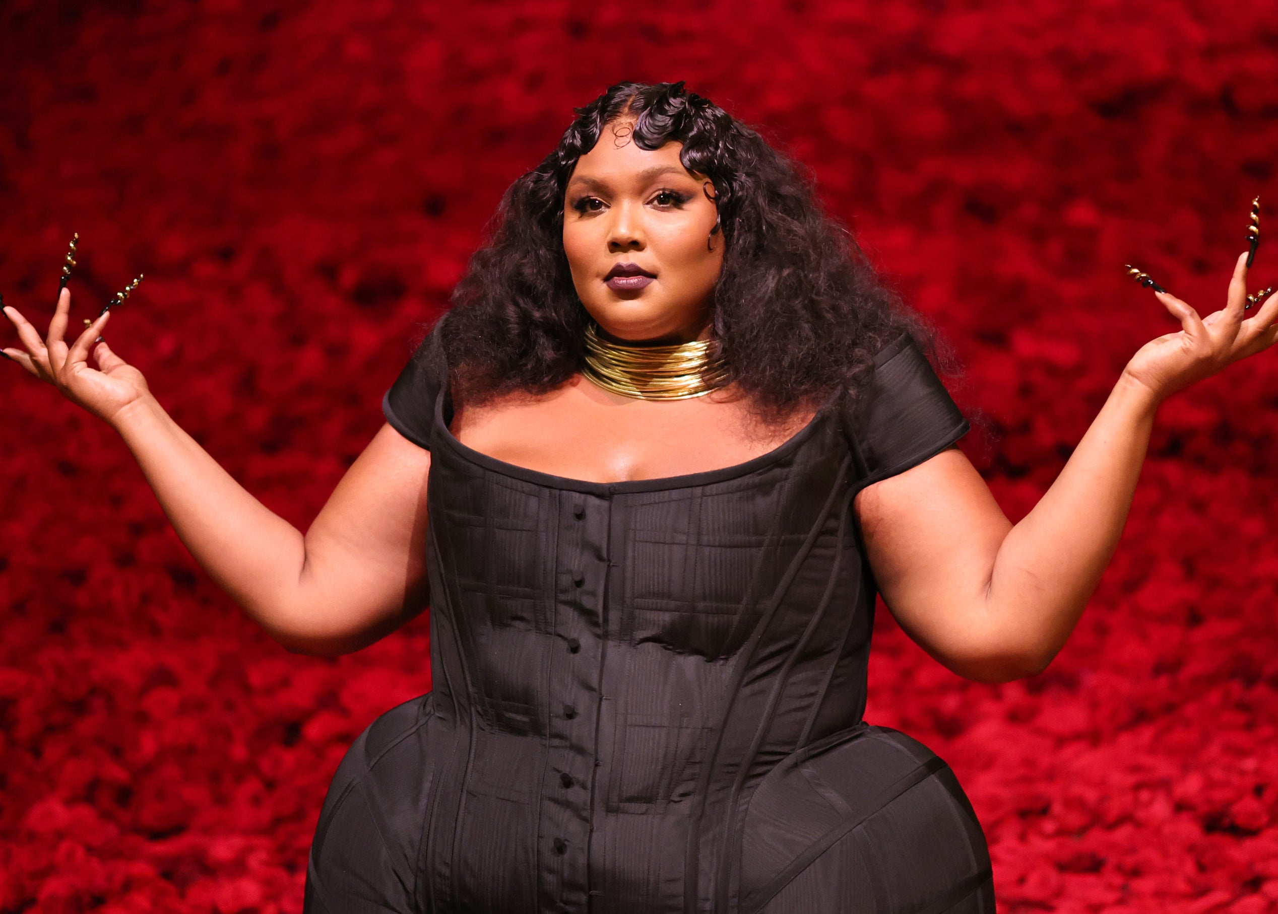 Lizzo holding her hands up as if to say &quot;What?&quot;