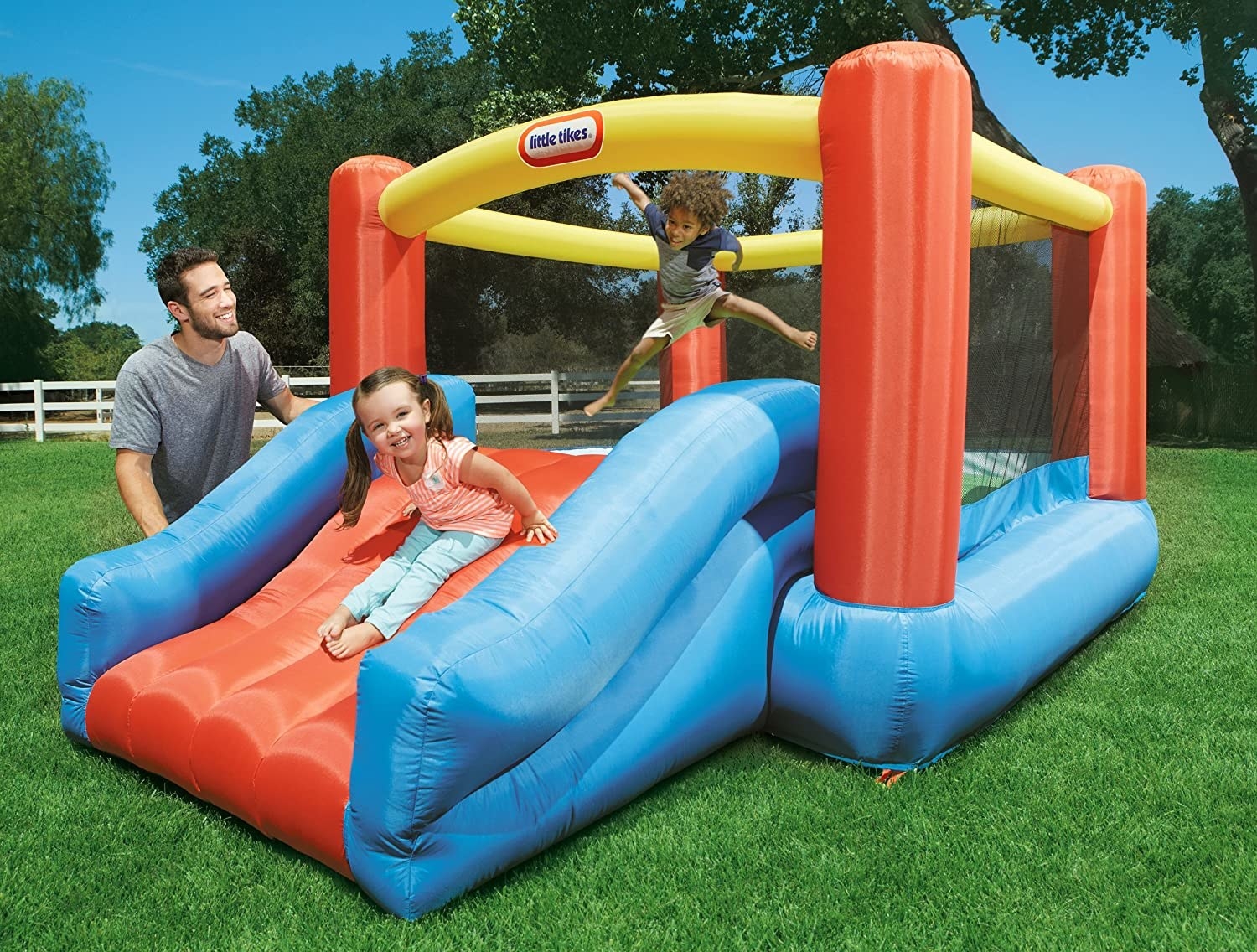 kids play on bouncy slide outdoors