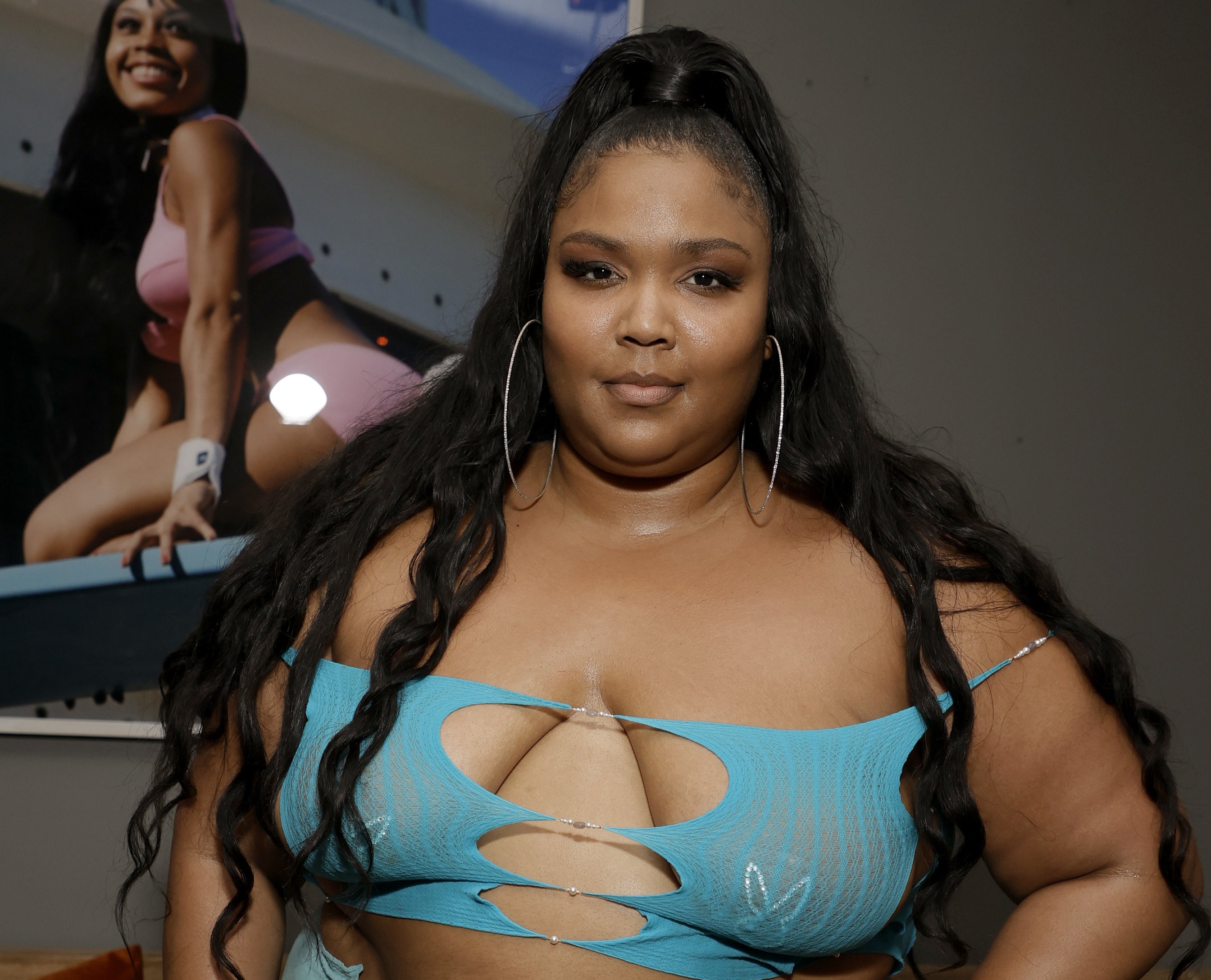 Lizzo in a spaghetti-strap top with a bustline-baring front