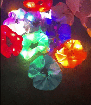 reviewer's gif of the scrunchies lighting up