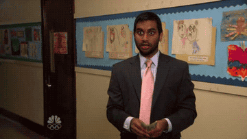 A gif of Aziz Ansari in Parks and Recreation waving money around