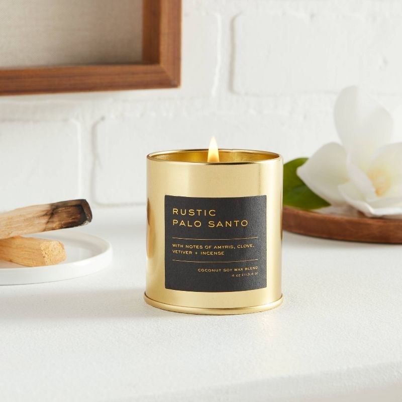 An image of a rustic palo santo candle with notes of clove, amyris, vetiver, and incense