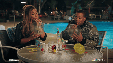 Characters drinking gigantic cocktails next to a pool