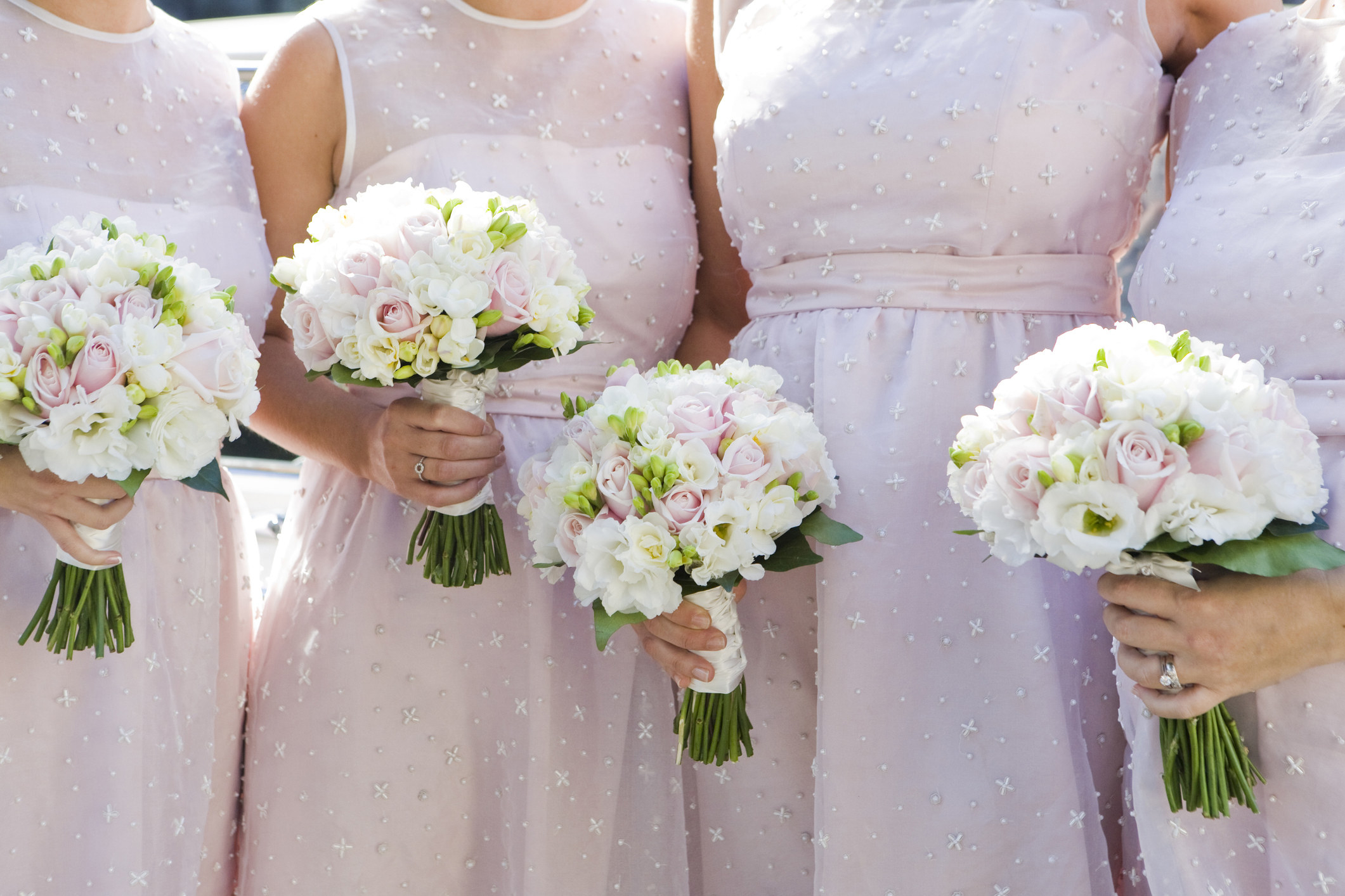 close up of bridesmaids holding bouquets