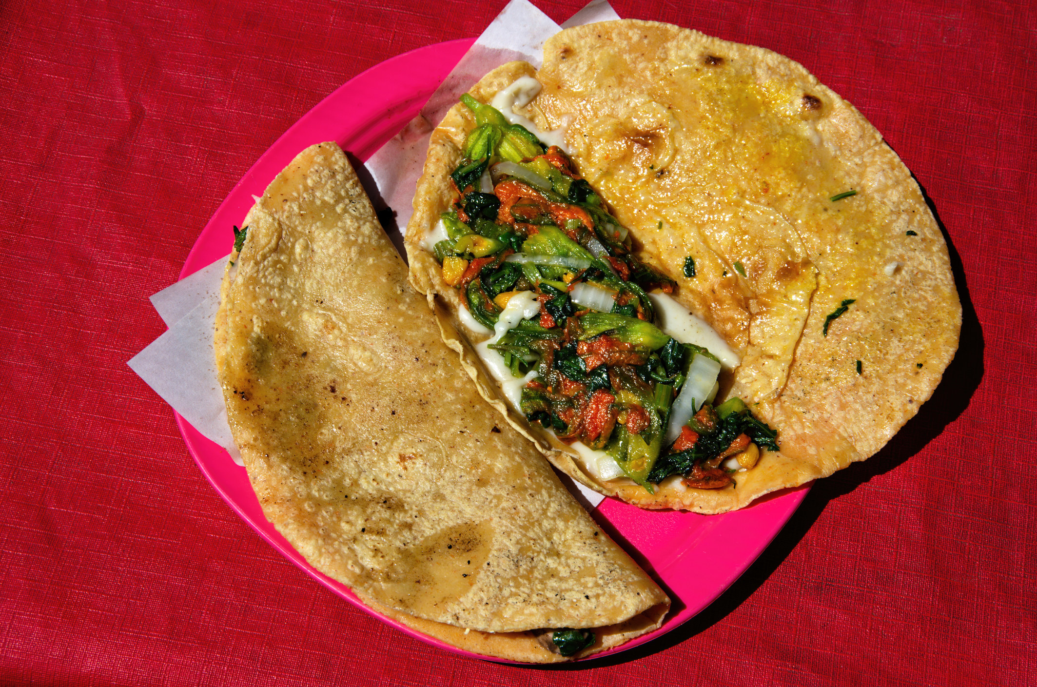 An authentic quesadilla on a red plate