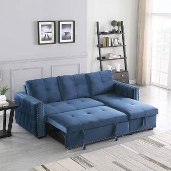 a blue sectional sofa in a sleeper position