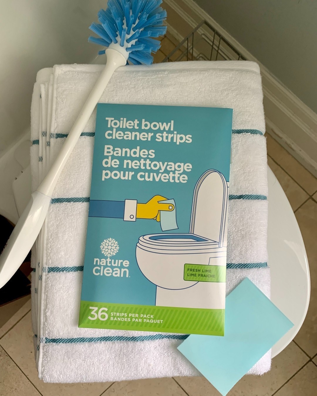 a flatlay of the toilet cleaning strips on top of a towel in a bathroom