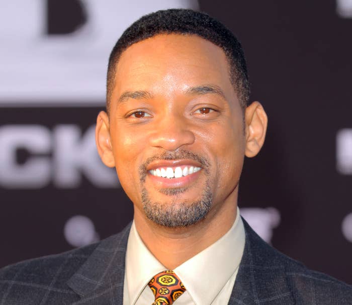 Will Smith smiles on at a red carpet event