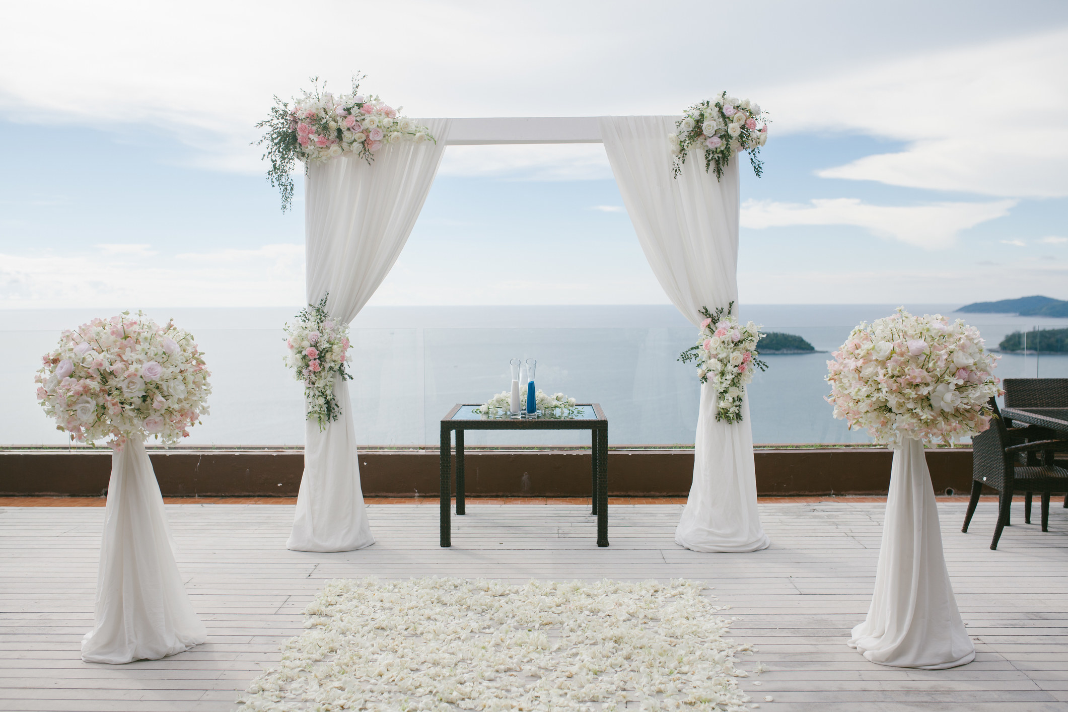 a wedding alter set up with beachside views