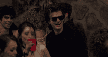Steve Harrington vibing at a party in a scene from Stranger Things