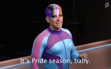 GIF of someone with a rainbow painted on their face saying &quot;It&#x27;s Pride season, baby&quot;