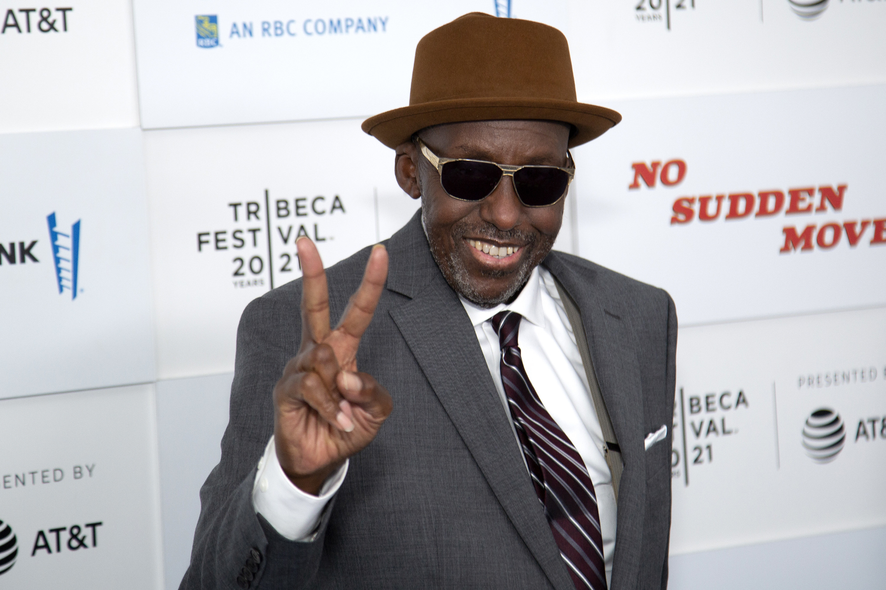 Bill Duke makes a peace sign with his fingers