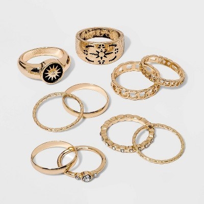 There are ten gold rings with crystal and black embellishments