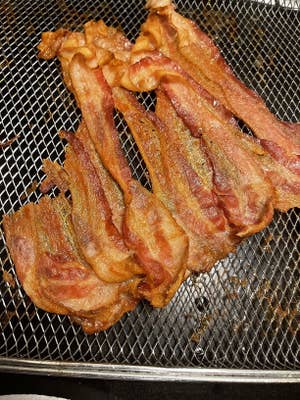 a reviewer's image of bacon fried in the toaster