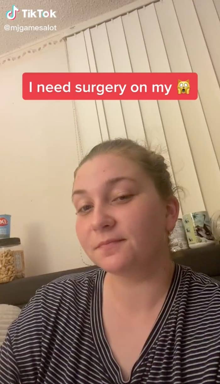 Melita frowning at the camera with a caption that says she needs surgery on her vagina