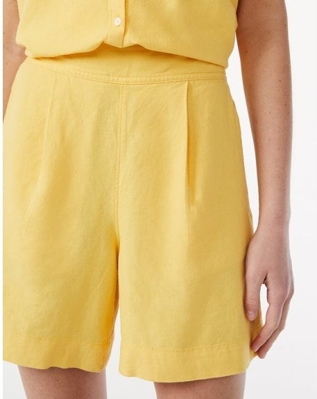Model wearing yellow shorts