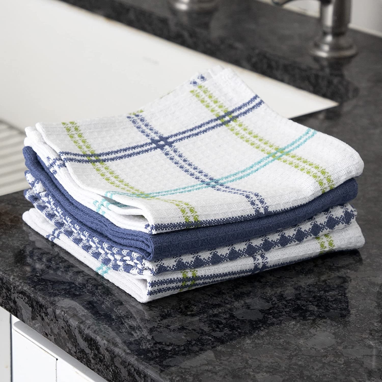 stack of plaid dishcloths on a kitchen counter