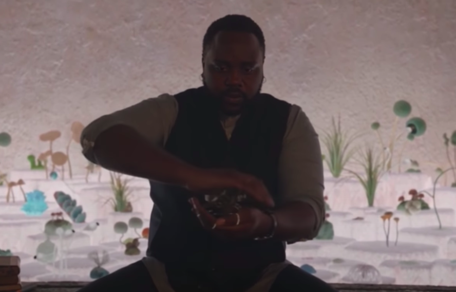 Brian Tyree Henry sitting down in character