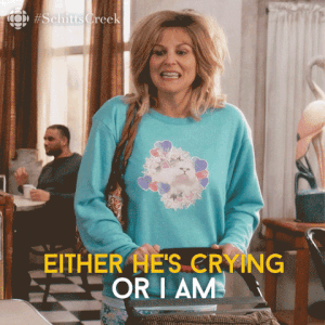gif of jocelyn schitt saying either he&#x27;s crying or i am while rocking baby stroller from schitt&#x27;s creek