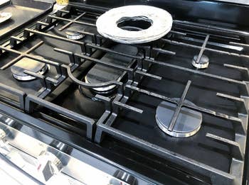 reviewer's stovetop with burner covers that blend in with the stove top