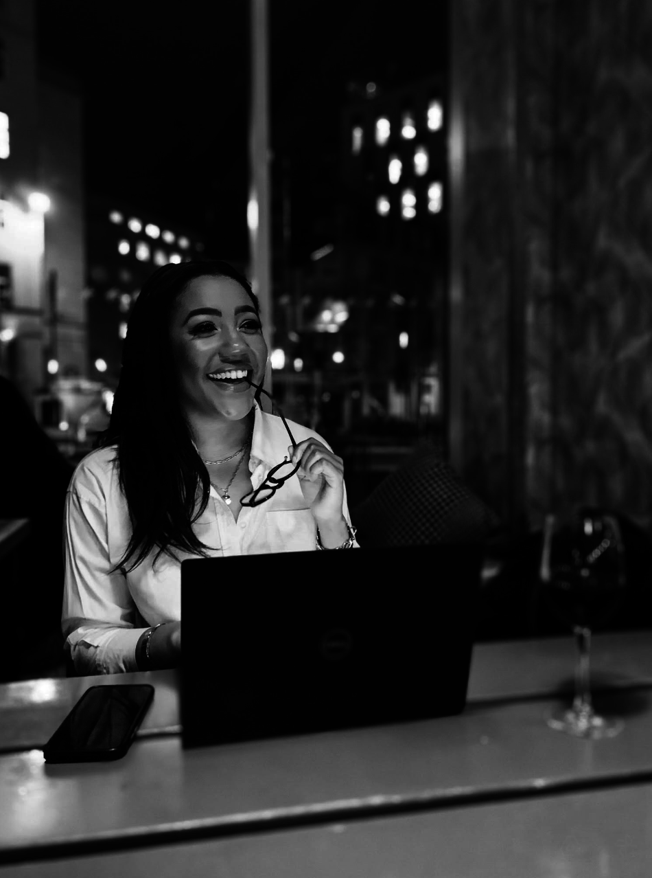 PIC woman smiling in front of computer